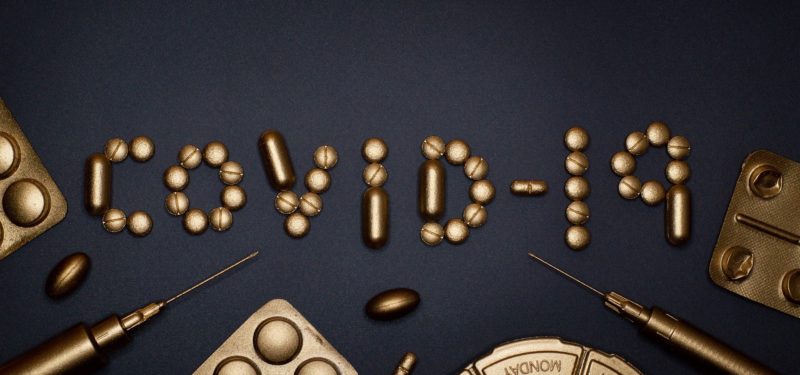 covid-19 written out in golden pills